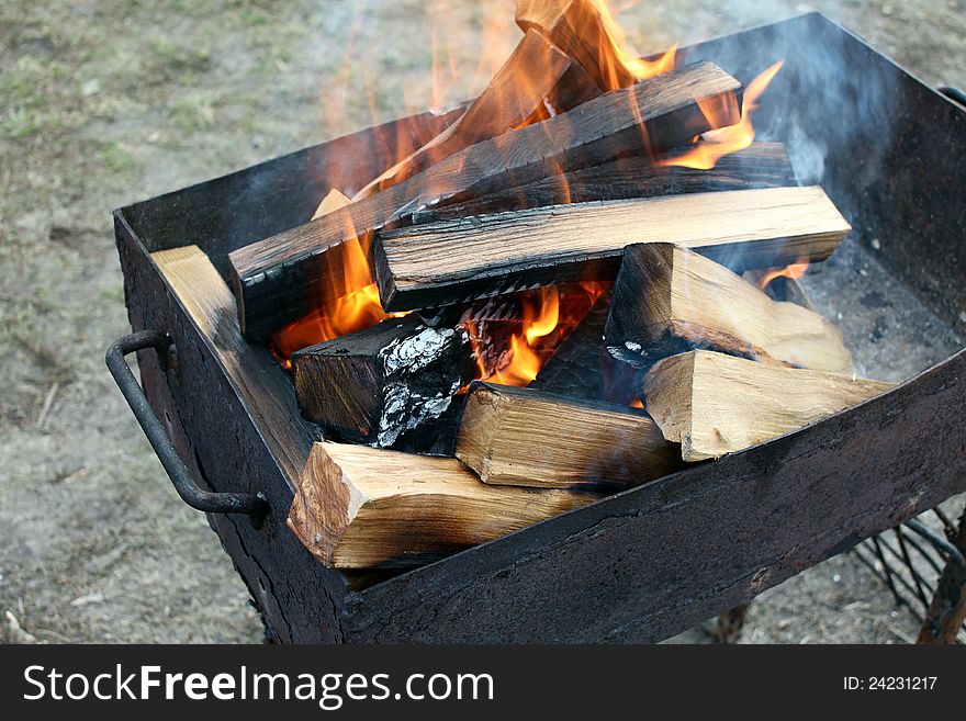 Burning wood in a brazier