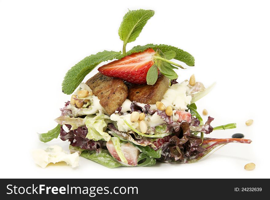 A salad of vegetables and meat on a white background