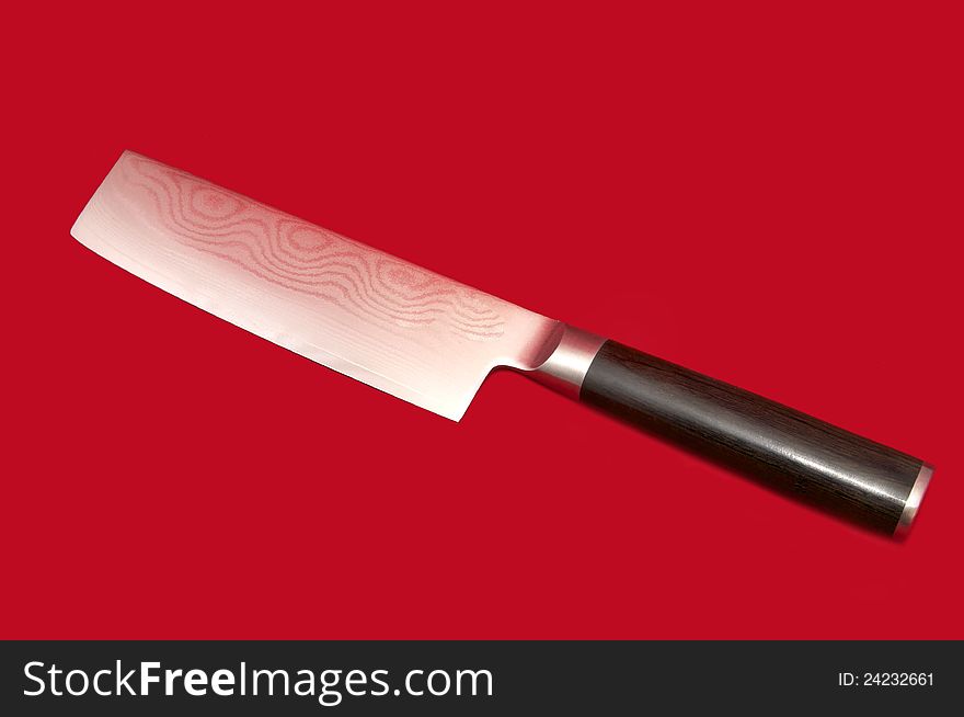Kitchen knife for meat on a red background