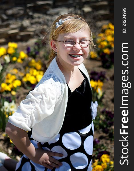 Image of a happy teenager posing in a flower garden. Image of a happy teenager posing in a flower garden