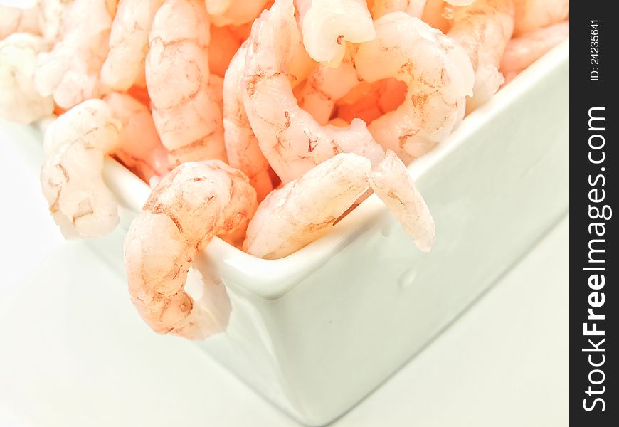 Peeled shrimps, close up, isolated in a white bowl