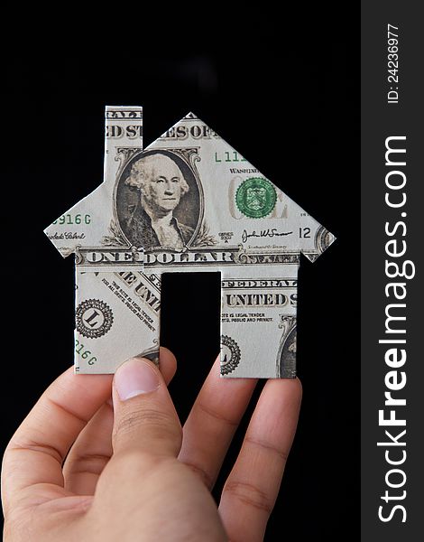 Hand holding banknote house icon