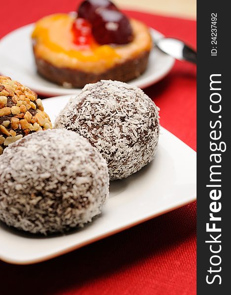 Chocolate cake with coconuts on the table. Selected focus