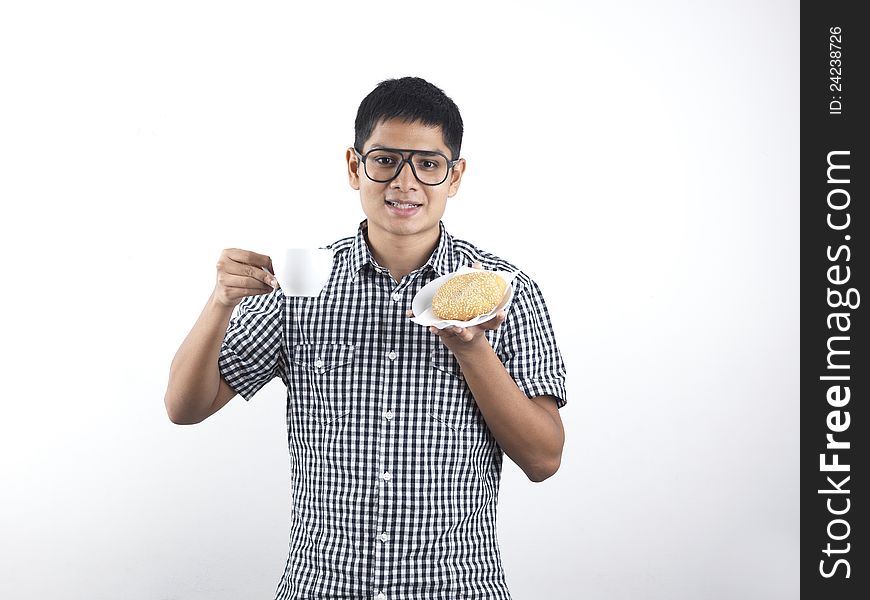 Indian Man holding Asian Pastry and cup