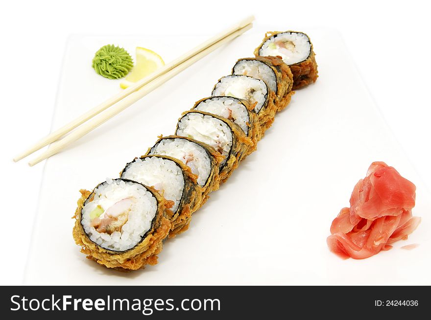 Portion of the rolls and chopsticks on white background