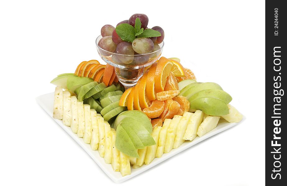 A large plate of fruit on a white background. A large plate of fruit on a white background