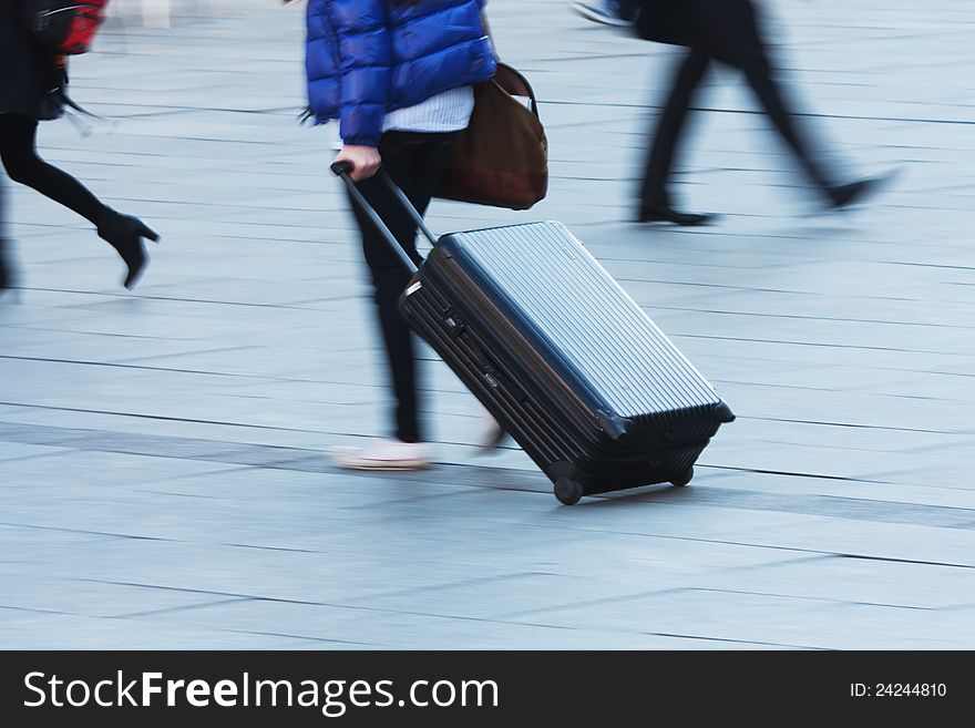 Travelling person with a trolley case