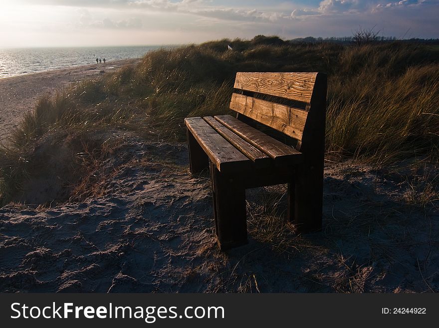 Bench on a dune with view on the Northern Sea in the background during sunset. The picture was taken on the Isle of FÃ¶hr in Northern Germany