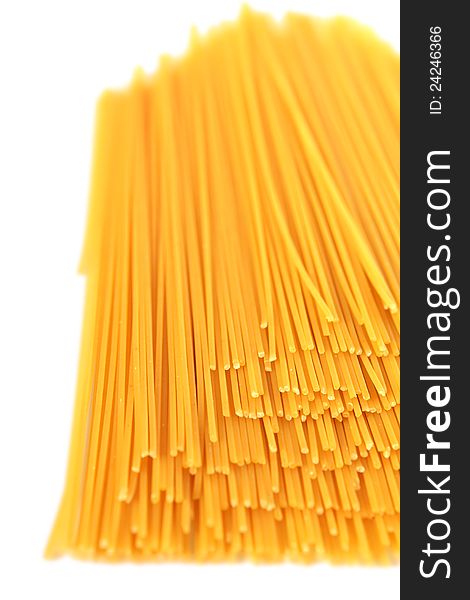 Spaghetti noodles stacked on a white background. Spaghetti noodles stacked on a white background