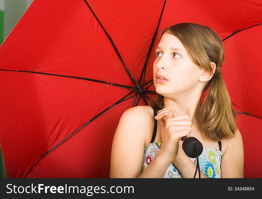 Teen with red umbrella is listening to the sound of falling drops od rain. Teen with red umbrella is listening to the sound of falling drops od rain.