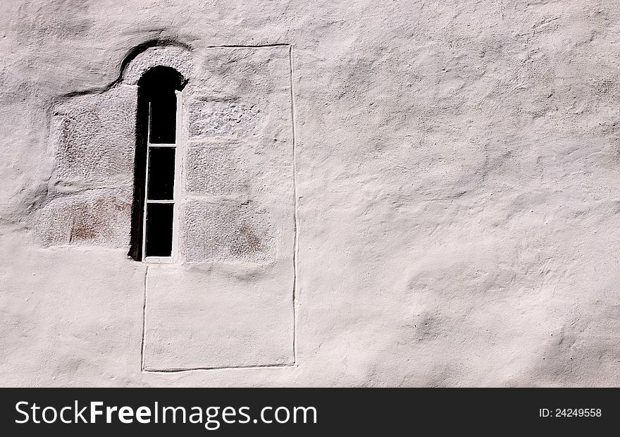 Old, small window on an exterior church wall