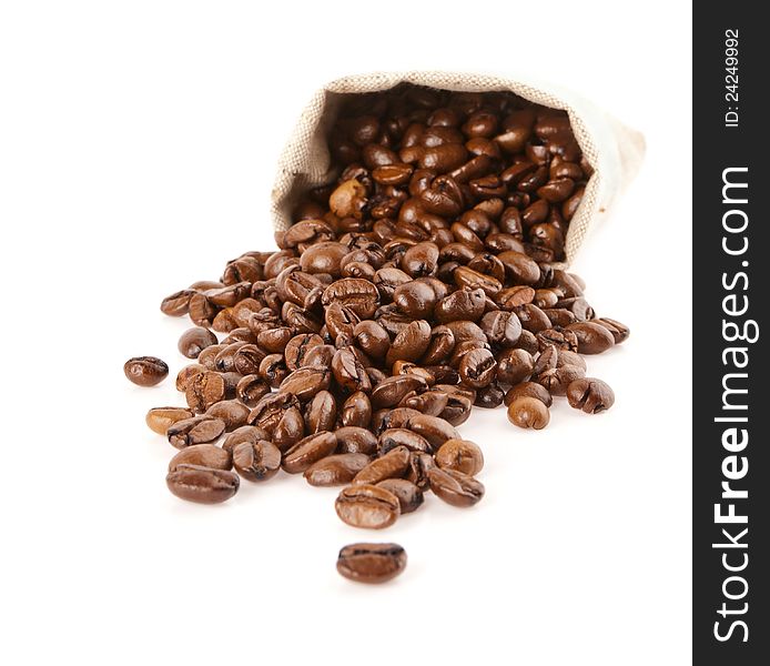 Grains of coffee pour out from a sack on a white background