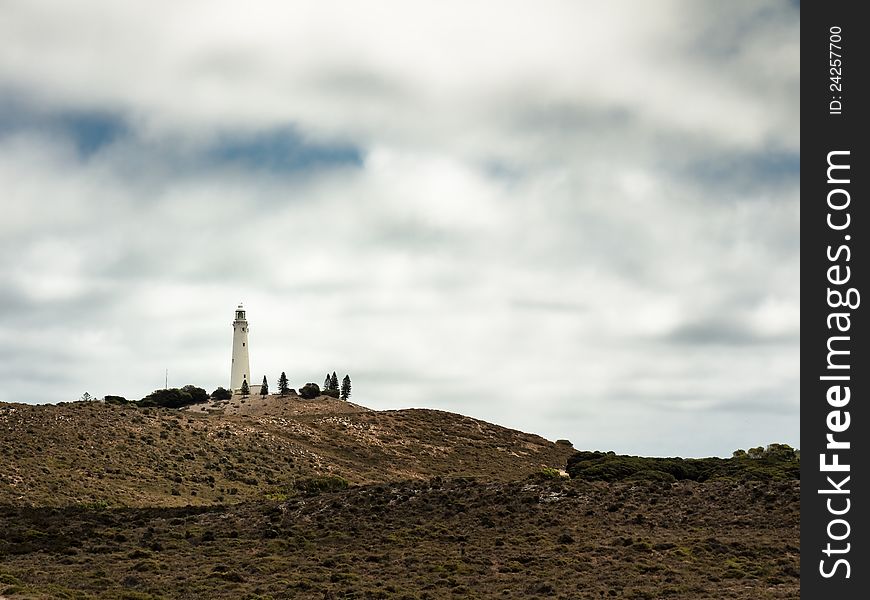 Lighthouse surrounded by vegetation in Rottnest Island, Australia.