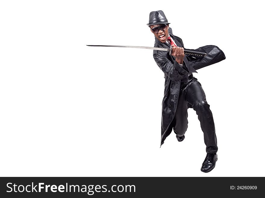 Black man wearing leather suit playing with sword. Black man wearing leather suit playing with sword