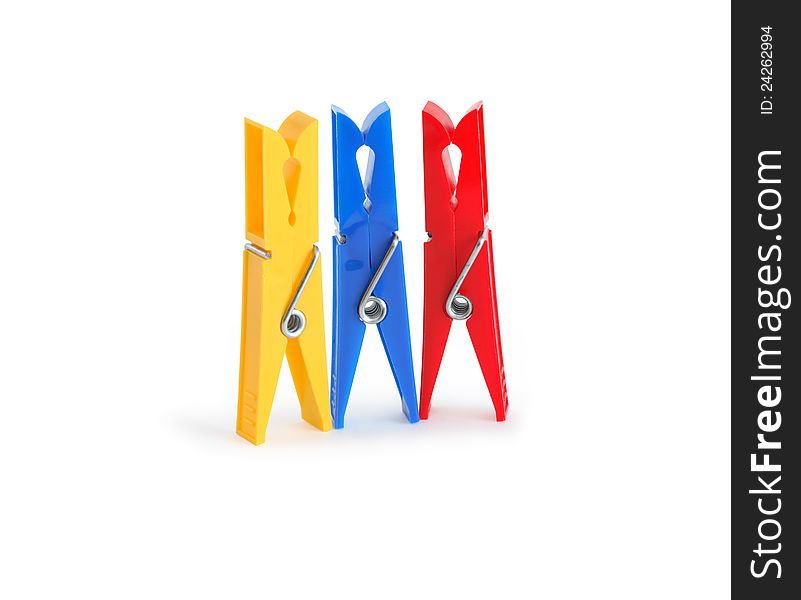 Three colored clothespins standing in a row on white background. Clipping path is included. Three colored clothespins standing in a row on white background. Clipping path is included