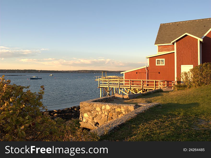 Red building at sunset along the coast of Maine. Red building at sunset along the coast of Maine.