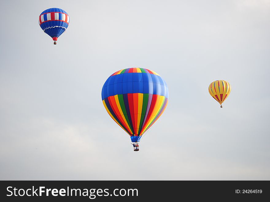 Three hot air balloons at the balloon festival.