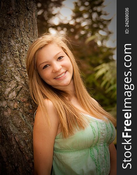 Teen girl at park with tree