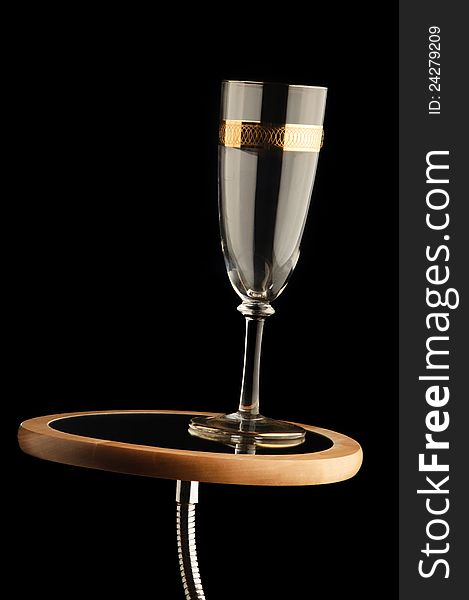 Empty champagne glass on mirror stand