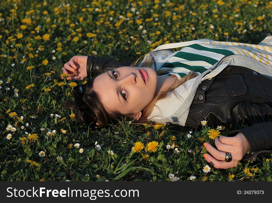 Girl lying on the field of dandelions. Girl lying on the field of dandelions.