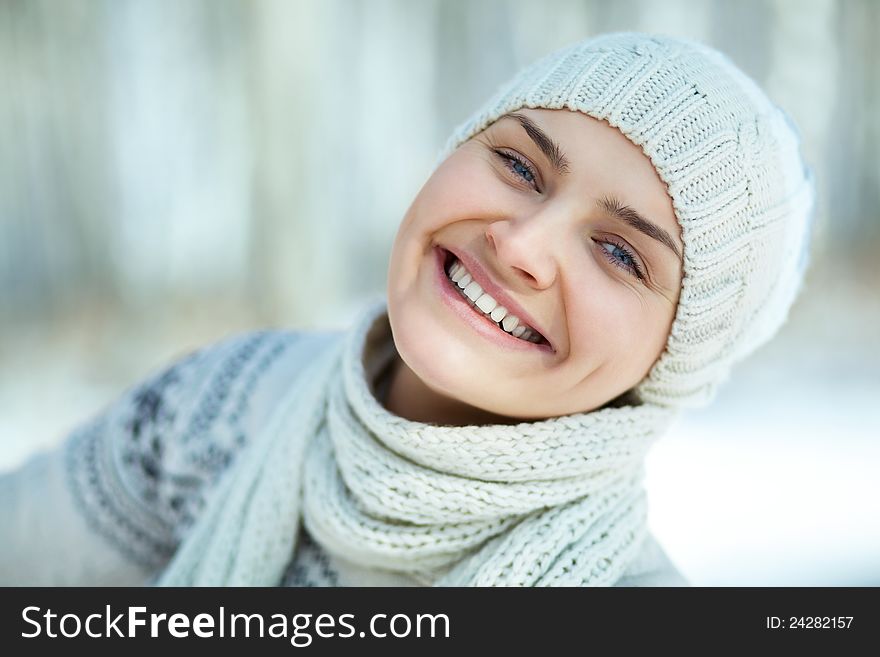 Portrait of a smiling young girl in a hat and scarf. Portrait of a smiling young girl in a hat and scarf