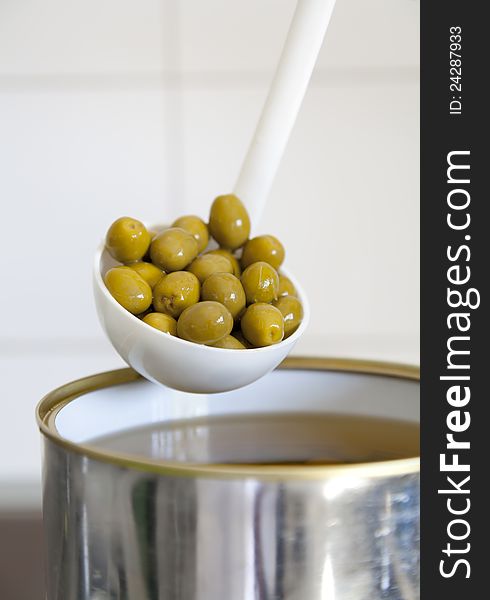 Picked green olives with a ladle to be served