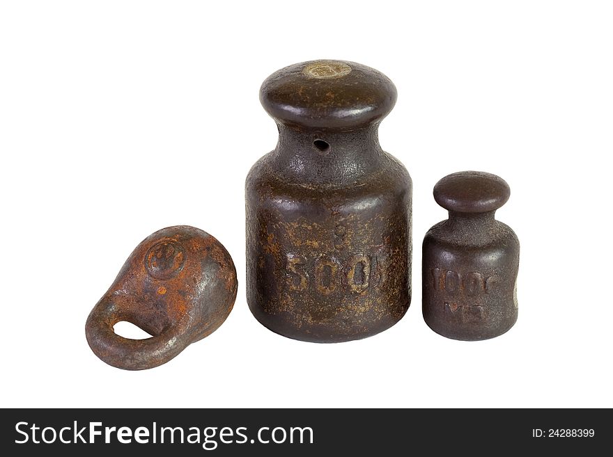 Three of the old weights for scales on a white background