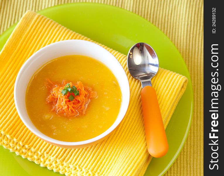 Pumpkin soup from carrots, potatoes and pumpkin decorated with onion