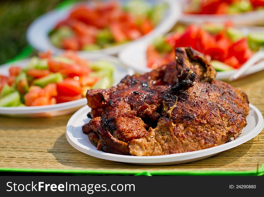 Fresh meat in white plate. Picnic picture proper for restaurant menu design.