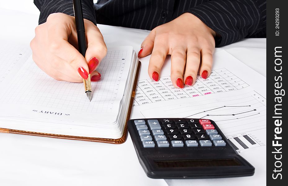 Business woman calculates and writes in the diary. Business woman calculates and writes in the diary