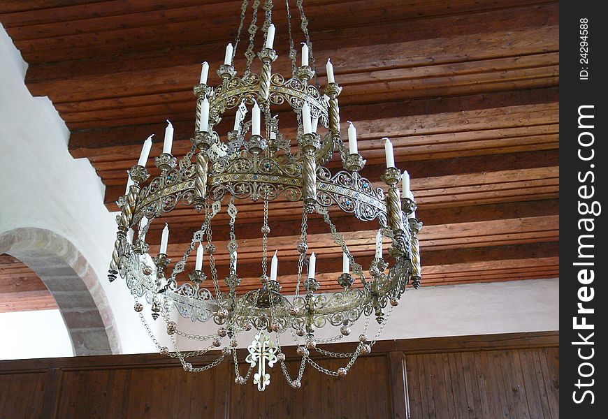 Hanging old ornamental chandelier in church