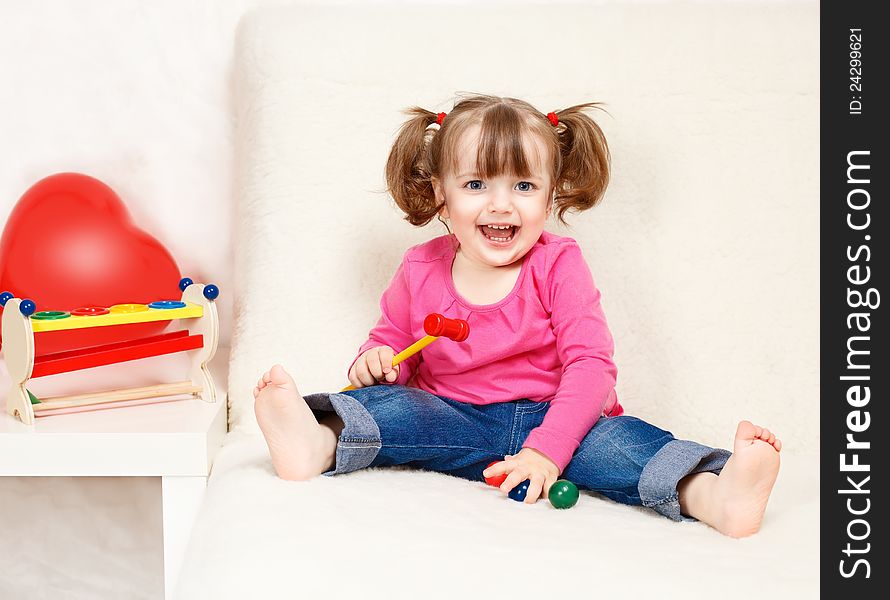 Little girl playing with toys