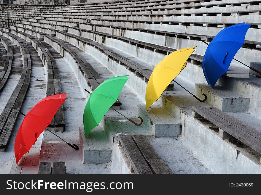Colorful umbrellas on the stadium seats. Colorful umbrellas on the stadium seats
