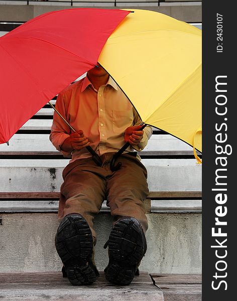 Red and yellow umbrella man in the stadium