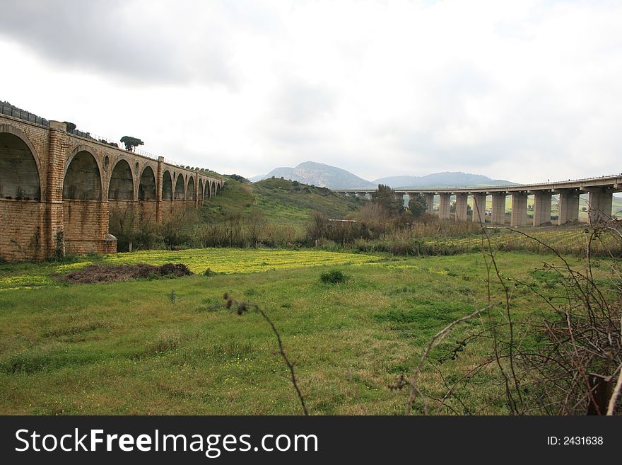 Country bridges for rails. Season Autumn. Green Cultivations. Fields and meadows Sicily. Italy