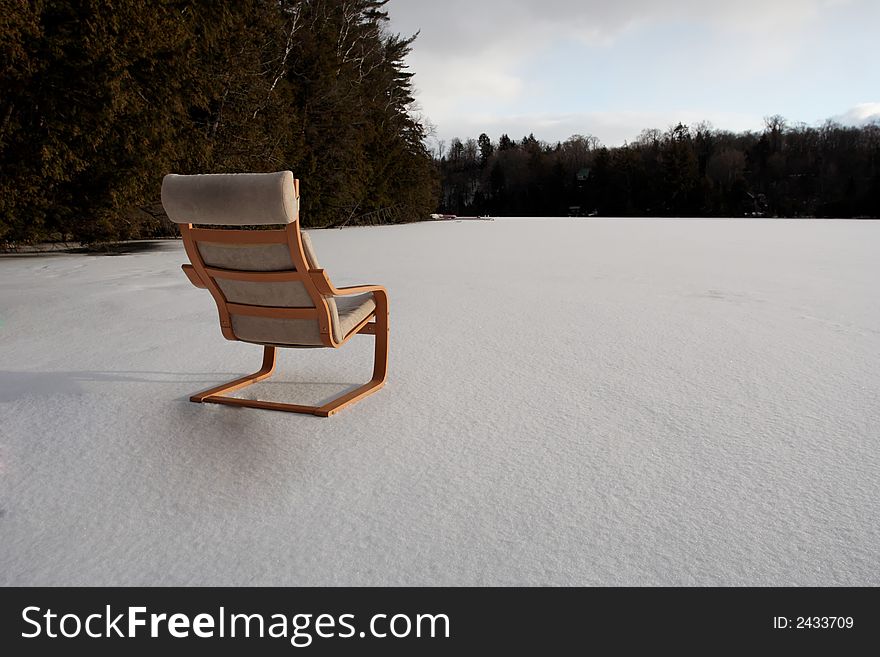 A luxury chair stands on a frozen lake. A luxury chair stands on a frozen lake