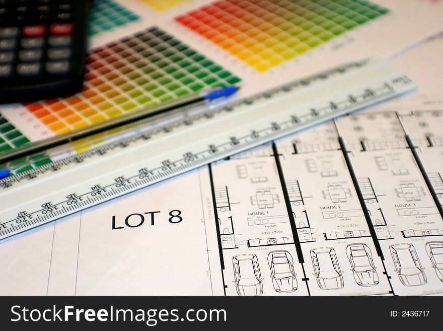 Colour chart, ruler, pen, calculator and plans... on a desk ready to be studied!. Colour chart, ruler, pen, calculator and plans... on a desk ready to be studied!