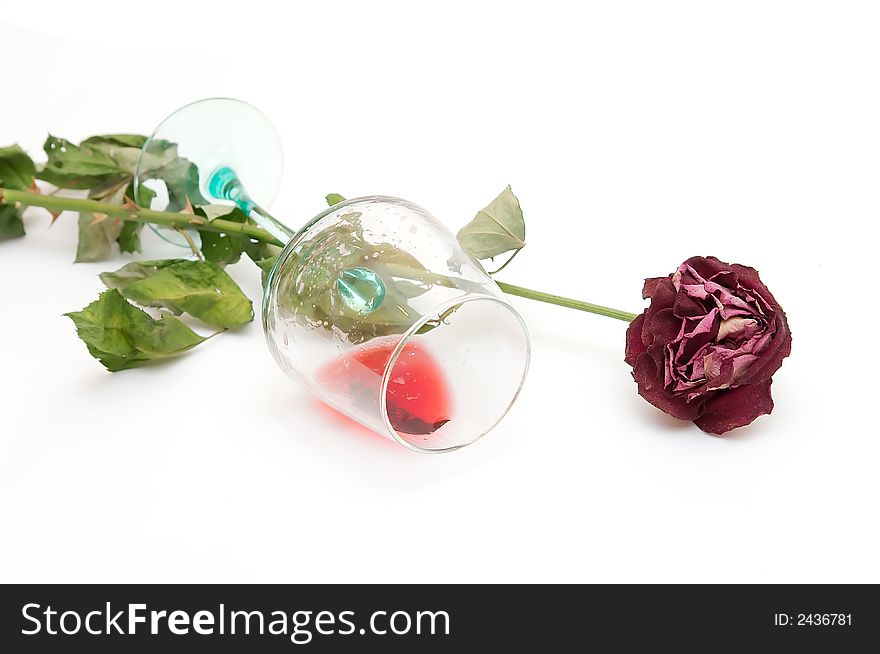 Red wine in a glass and a dried up rose. Red wine in a glass and a dried up rose