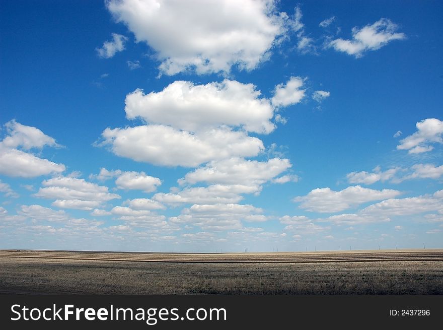 Sky above the field and clouds