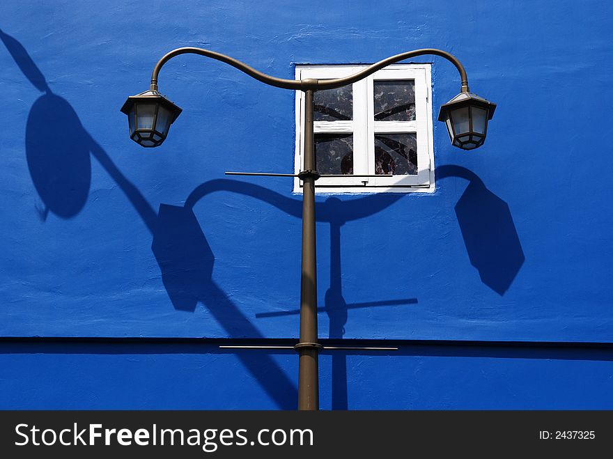 Blue wall and street lamp post