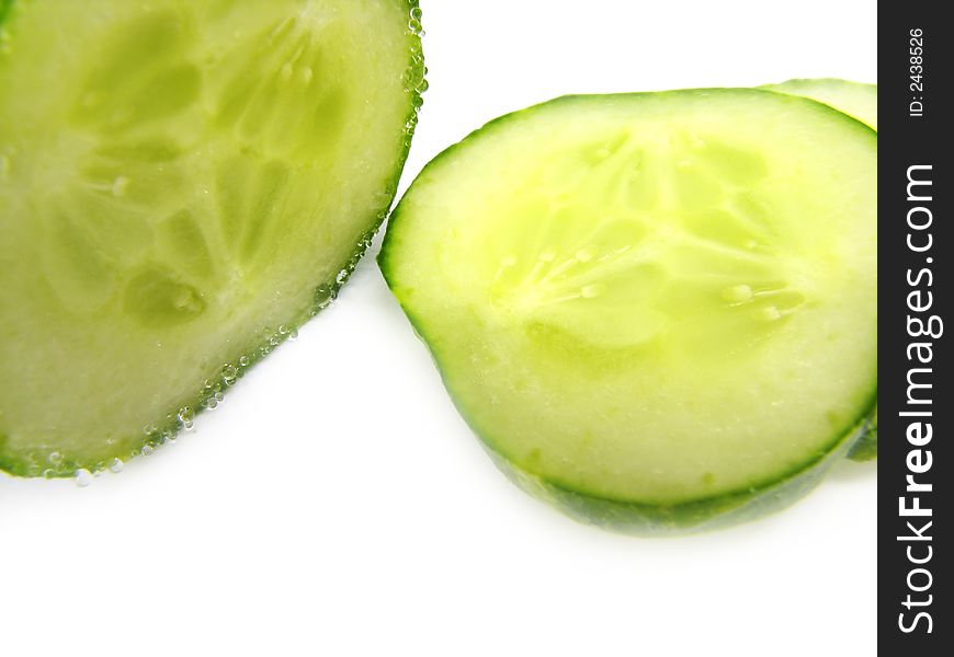 Slices of a cucumber, separately, on a white background. Slices of a cucumber, separately, on a white background.