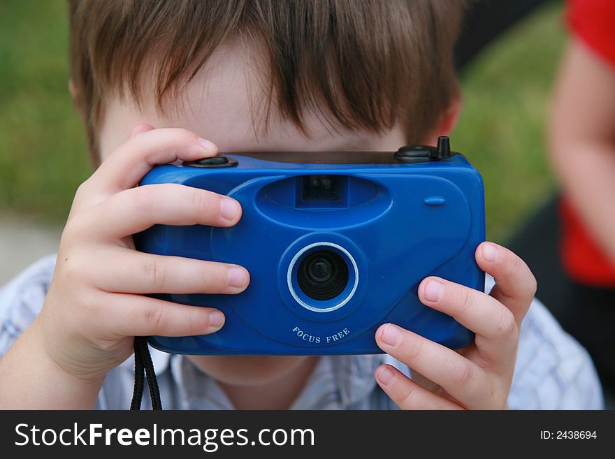 Little boy with blue camera. Little boy with blue camera