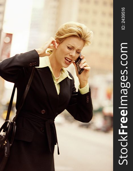 Female executive using cell phone on downtown street. Female executive using cell phone on downtown street