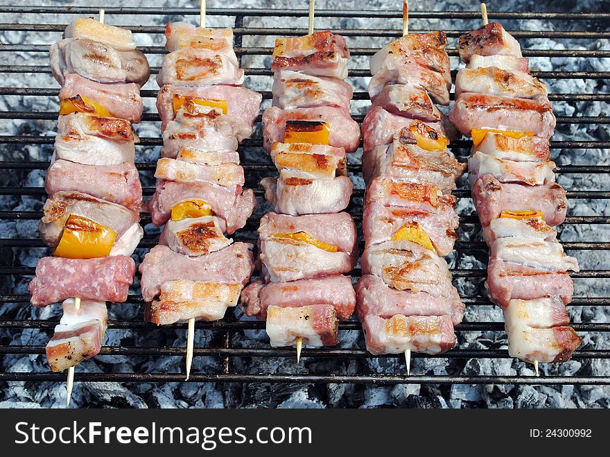 Cocked pork kabobs grilled on skewers on a barbecue