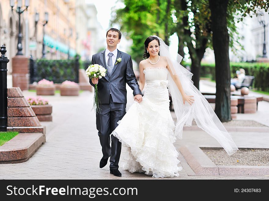 Bride And Groom Having Fun In An Old Town