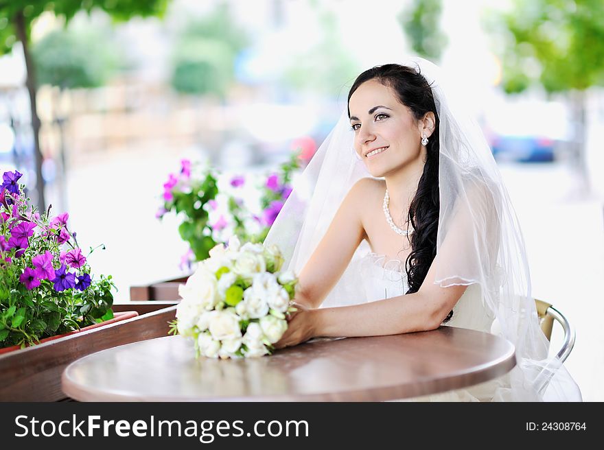 Happy young bride holding bridal bouquet