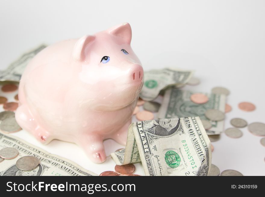 Pink piggy bank with coins and dollars. Pink piggy bank with coins and dollars