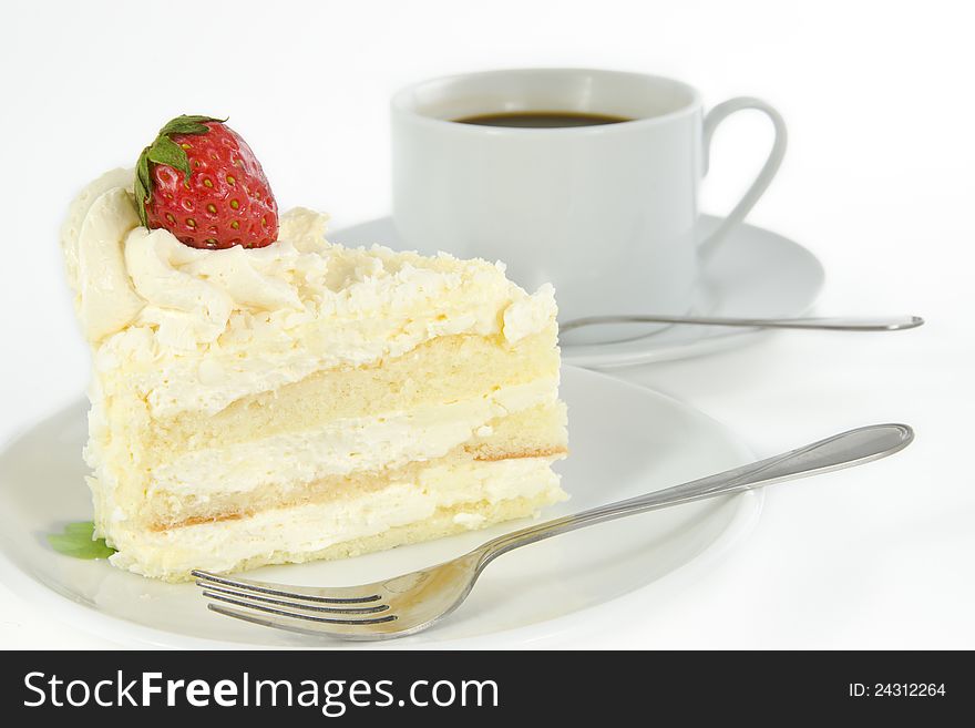 Delicious vanilla cake with strawberry decorate on top and a cup of coffee. Delicious vanilla cake with strawberry decorate on top and a cup of coffee