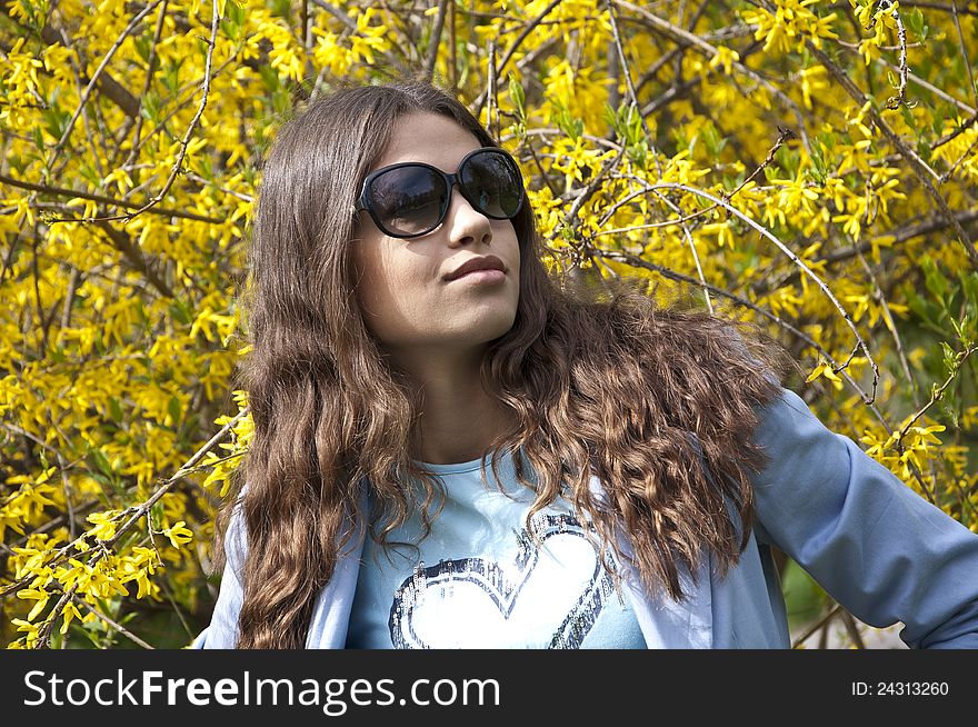Beautiful young girl dress up in spring clothes with sunglasses. Beautiful young girl dress up in spring clothes with sunglasses