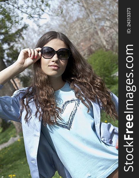 Beautiful young  girl dress up in spring clothes with sunglasses. Beautiful young  girl dress up in spring clothes with sunglasses